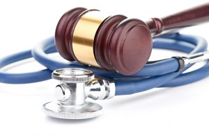 brown gavel and a medical stethoscope