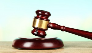 Judges gavel on wooden table on light background