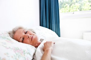 Senior woman sleeping in bedroom at home