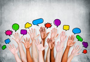Multi Ethnic People's Hands Raised with Speech Bubble