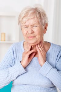 Woman having sore throat