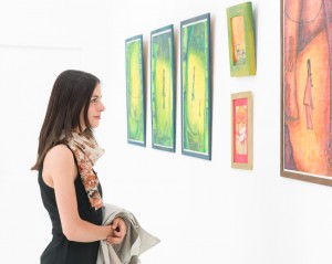 woman admiring colorful painting