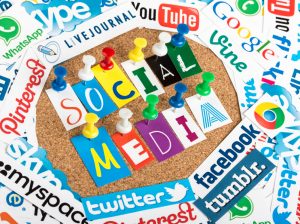 BELGRADE - JUNE 13, 2014 Social media words made from letters pinned to a cork bulletin board and social media website logos printed on paper