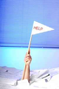 hand with help flag sticking out of papers