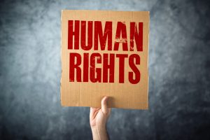 Man holding cardboard paper with HUMAN RIGHTS title