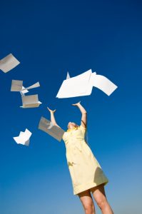 businesswoman throws up her papers