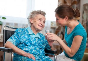Senior woman with her caregiver at home