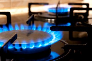 Black gas stove and two burning flames close-up