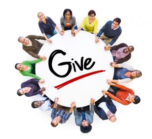 Group of People Holding Hands Around the Word Give