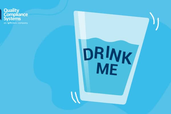 A glass of water wit the words 'Drink Me' written on it