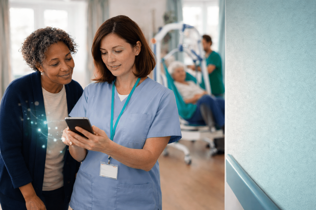 Two social care professionals reviewing guidance on a tablet in a calm UK care home corridor.